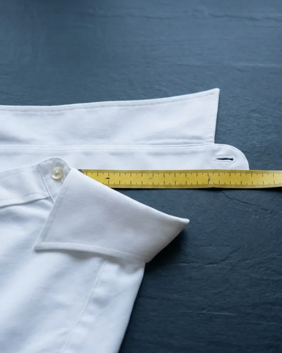 Measuring a shirt collar from the button to the end of the buttonhole