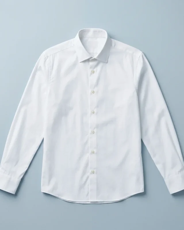A white dress shirt laid flat with sleeves extended